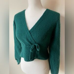 Super soft cropped mock wrap emerald green sweater with side tie detail. Size M